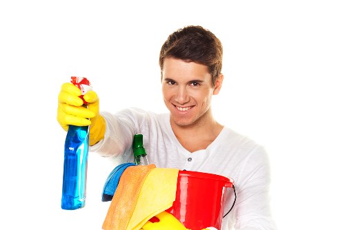 Cleaner applying stain treatment during a carpet cleaning appointment