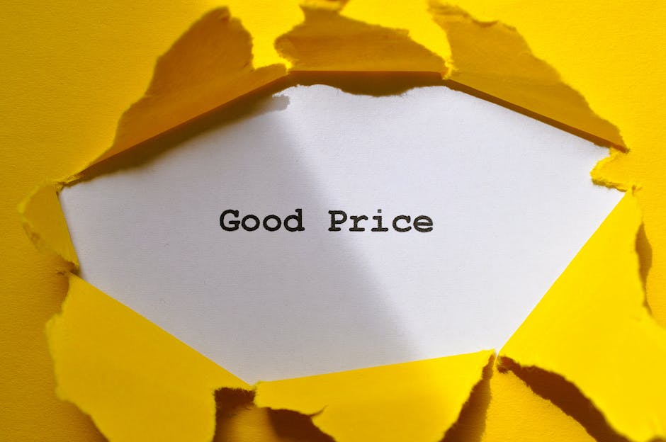 An image showing a piece of yellow paper torn in a jagged pattern, revealing a white surface underneath with the words 'Good Price' printed in bold black letters. The torn edges of the yellow paper ar